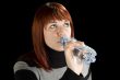 Redhead girl drinking water