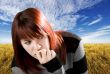Pensive redhead girl biting nail