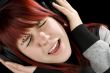 Girl holding headphones and singing