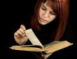 Girl turning book pages