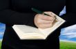 Female hand writing in a notebook