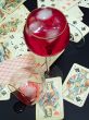 Broken glass, wine with ice and cards