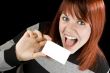Cute redhead holding blank business card