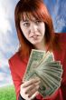 Surprised girl waving American dollars