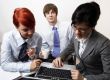 confident young manager at work with laptop