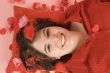 young beautiful woman laying on a red pillow