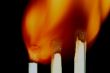 Match with smoke isolated in dark background