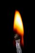 Match with smoke isolated in dark background