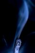 Match with smoke isolated in dark background