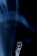 Match with smoke isolated in dark background