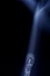 Match with smoke isolated in dark background