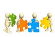 Four puppets, holding in hands a puzzle
