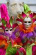 Two Venetian masks in bright, color suits