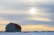 Old wooden barn in a snowy field