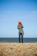 Girl standing on the beach and recording video