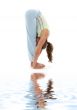 uttanasana standing forward bend on white sand