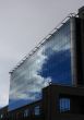 Dark clouds in a glass facade.