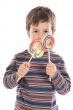 Child eating two lollipops