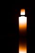 Light candle isolated on black