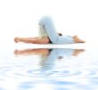 halasana plow pose on white sand