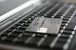 A shot of a laptop and a credit card in an office environment, can be used as e-commerce concept
