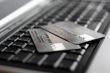 A shot of a laptop and a credit card in an office environment, can be used as e-commerce concept