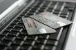A shot of a laptop and a credit card in an office environment, can be used as e-commerce concept