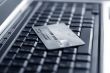 A shot of a laptop and a credit card in an office environment, can be used as e-commerce concept