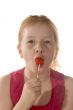 A young child enjoys a lollypop