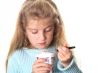 little girl looking at her yogurt