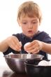 little boy cracking an egg