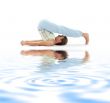 halasana plow pose on white sand #2