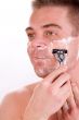 Shaving his cheek