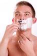 Young man is shaving