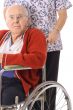 handsome elderly man in wheelchair with nurse