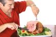man slicing a ham