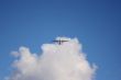 Plane on a blue and cloudy sky