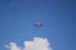 Plane on a blue and cloudy sky