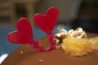 Glazed chocolate cake with two red lovely hearts