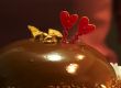 Glazed chocolate cake with two red lovely hearts