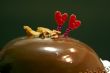 Glazed chocolate cake with two red lovely hearts