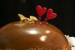Glazed chocolate cake with two red lovely hearts