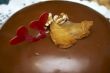 Glazed chocolate cake with two red lovely hearts