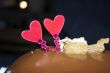 Glazed chocolate cake with two red lovely hearts