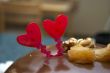 Glazed chocolate cake with two red lovely hearts