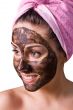 Beautiful girl with mud mask on face