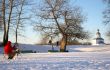 artist painting a chapel from life in winter