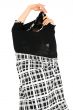 Woman taking off black and white dress