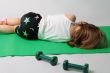 Small girl is tired to make power training.