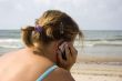Woman talking by phone in beach